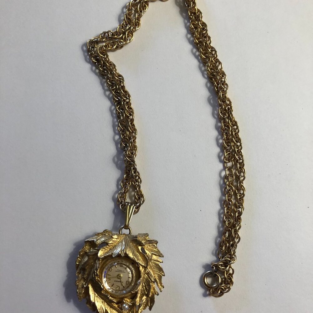 Vintage gold toned clock pendant with laurel leaves and chain